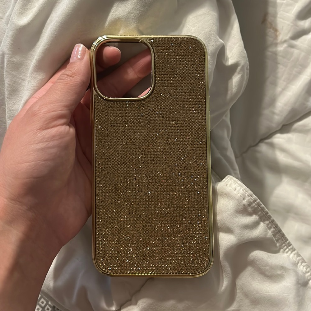 Beautiful gold colored bedazzled iPhone 12/13 pro max phone case.